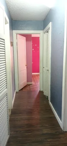 a view of a room with wooden floor and windows