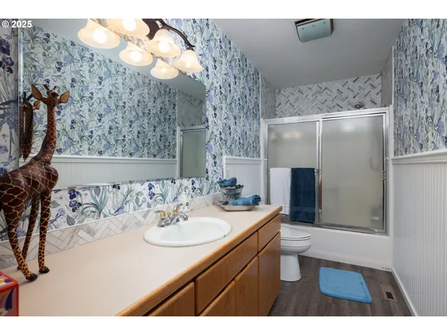 a bathroom with a sink vanity and mirror
