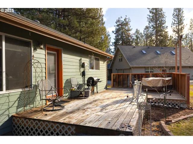 a view of a patio with table and chairs with wooden fence and plants