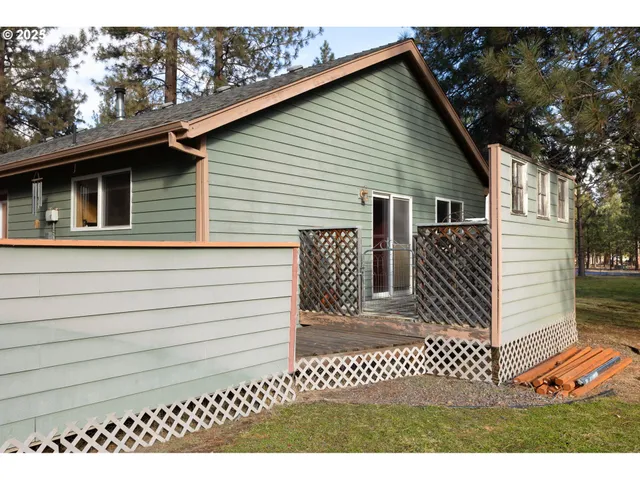 a view of a house with a wooden bench