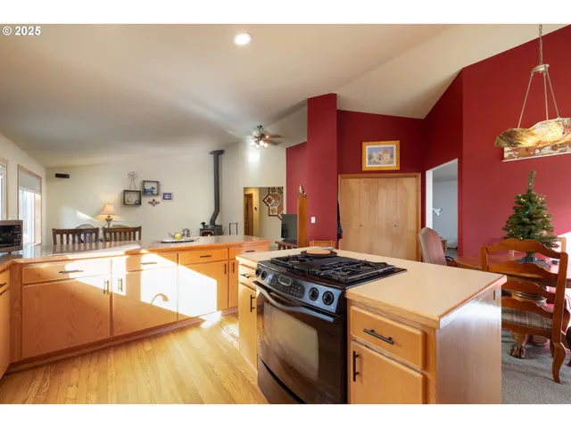 a kitchen that has a stove and a table