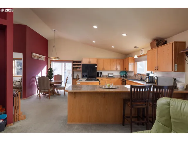 a kitchen with kitchen island a sink table and chairs