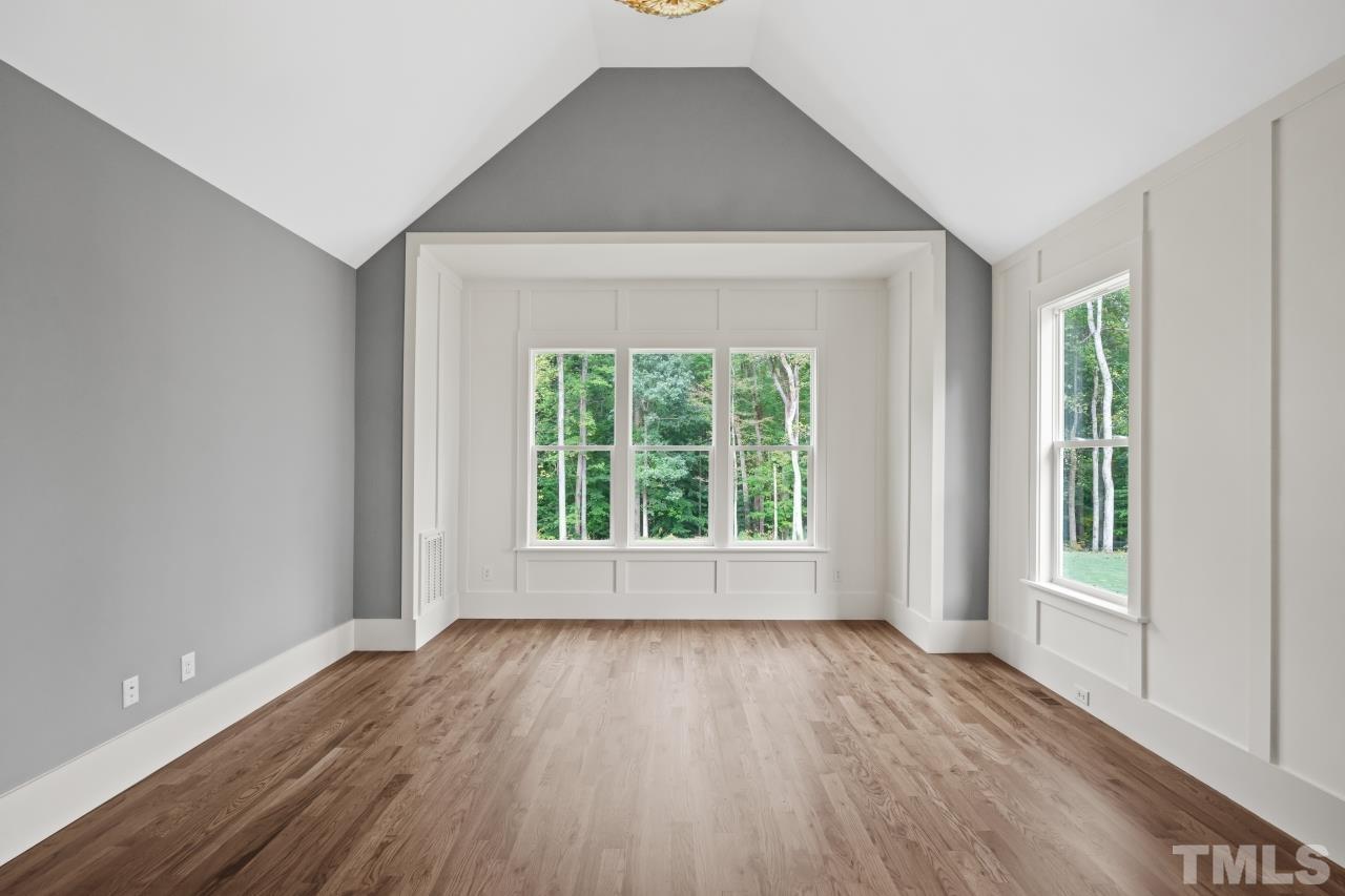 7204 Sing Along Court Raleigh, NC 27613 - Photo 12 of 46 an empty room with wooden floor and windows
