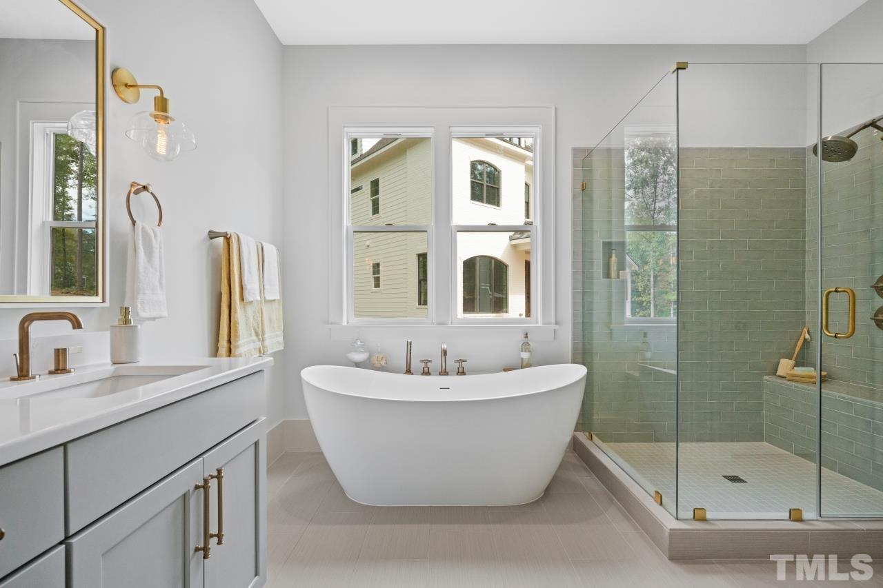 7204 Sing Along Court Raleigh, NC 27613 - Photo 13 of 46 a bathroom with a bathtub and a shower