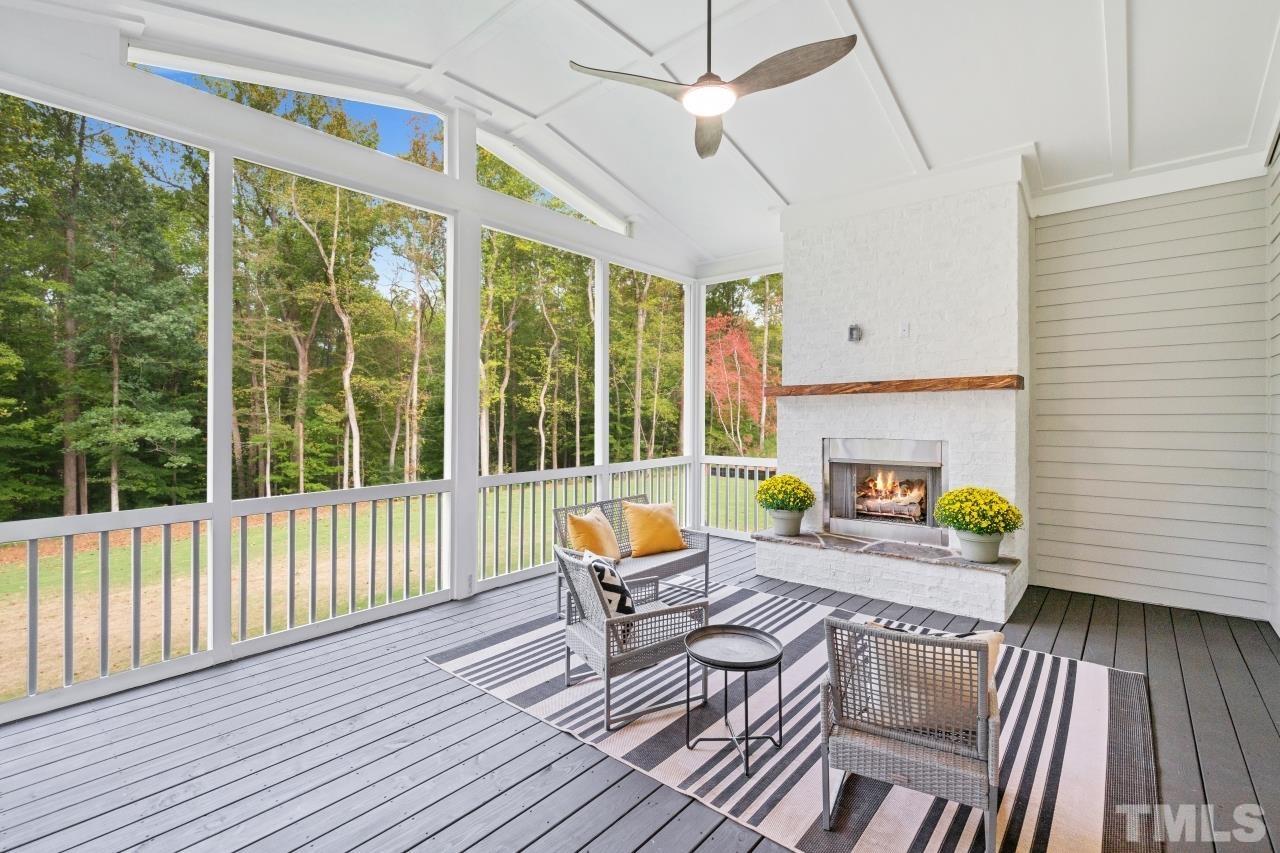 7204 Sing Along Court Raleigh, NC 27613 - Photo 19 of 46 a patio with lawn chairs and wooden floor