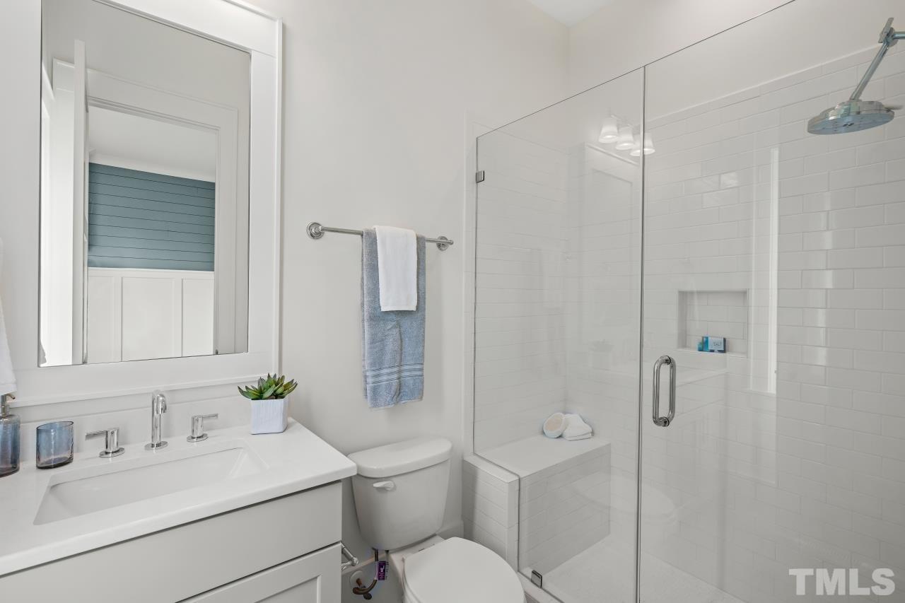 7204 Sing Along Court Raleigh, NC 27613 - Photo 2 of 46 a bathroom with a sink toilet vanity and shower