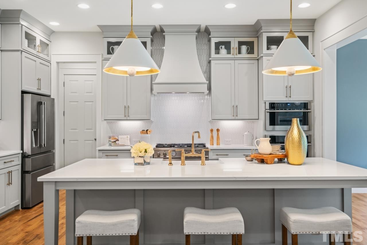 7204 Sing Along Court Raleigh, NC 27613 - Photo 22 of 46 a kitchen with stainless steel appliances a sink and a refrigerator