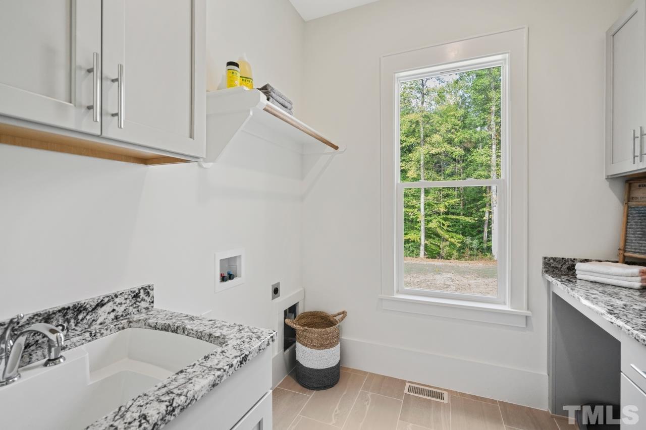 7204 Sing Along Court Raleigh, NC 27613 - Photo 32 of 46 a bathroom with a granite countertop sink and a bathtub