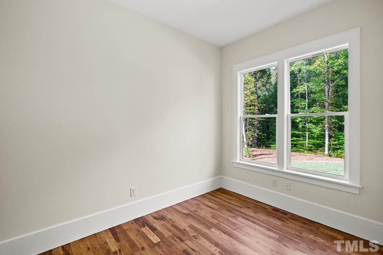 7204 Sing Along Court Raleigh, NC 27613 - Photo 35 of 46 a view of an empty room with wooden floor and a window