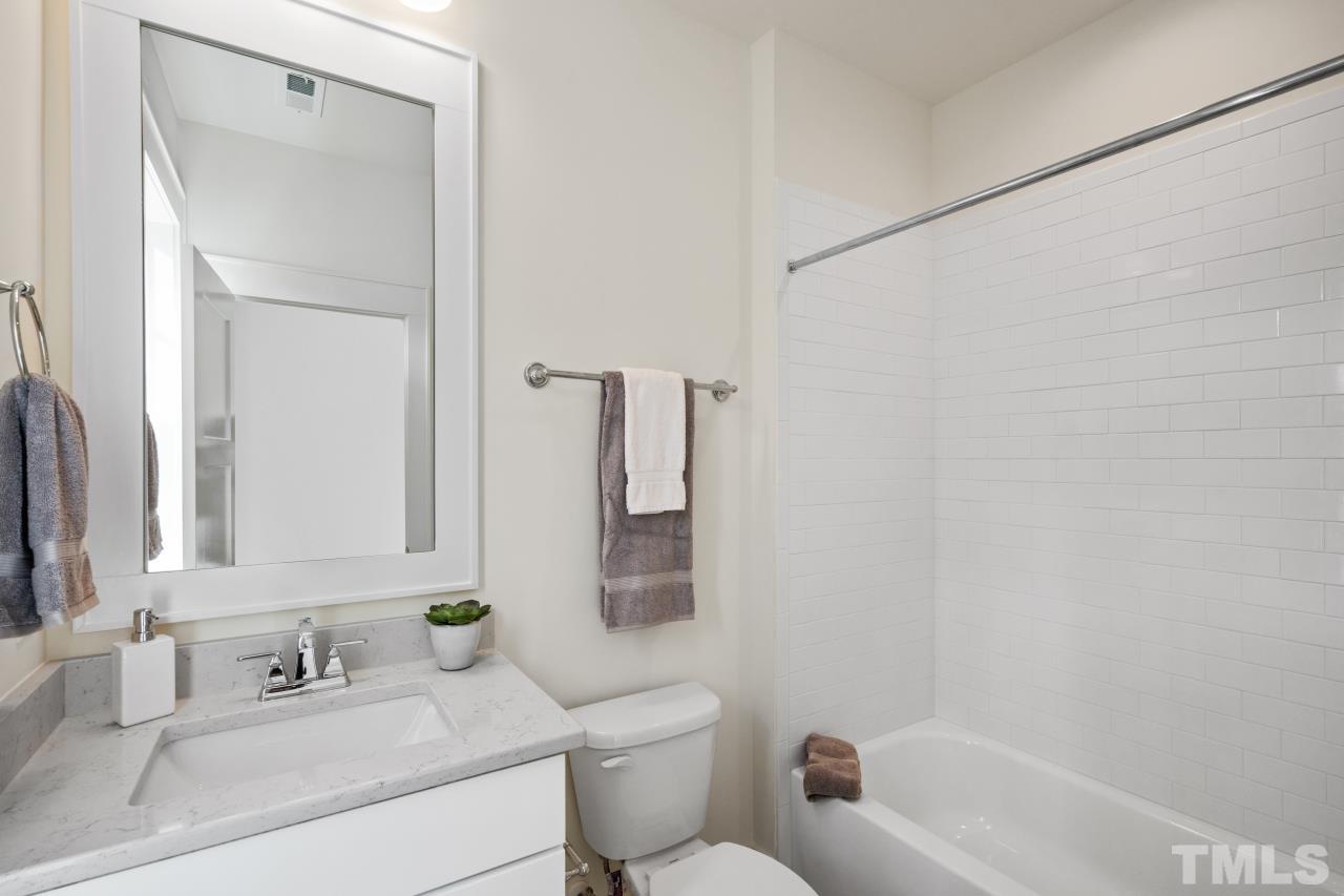 7204 Sing Along Court Raleigh, NC 27613 - Photo 38 of 46 a bathroom with a sink toilet and shower