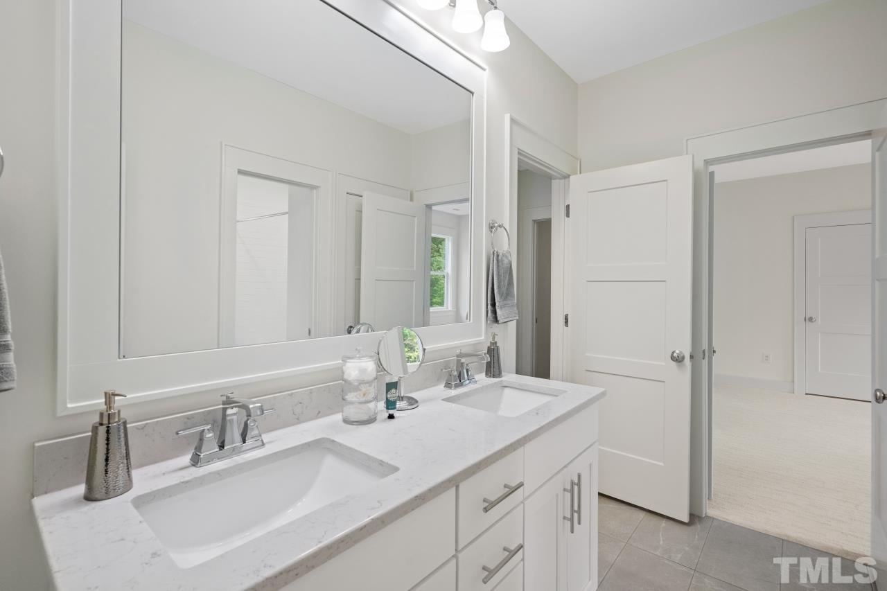 7204 Sing Along Court Raleigh, NC 27613 - Photo 39 of 46 a bathroom with a sink and a mirror