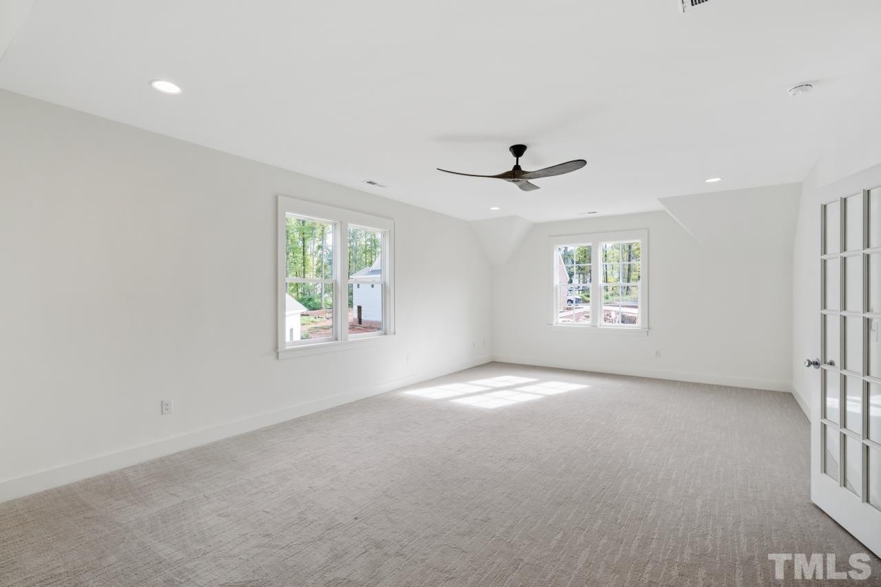 7204 Sing Along Court Raleigh, NC 27613 - Photo 40 of 46 an empty room with windows and ceiling fan