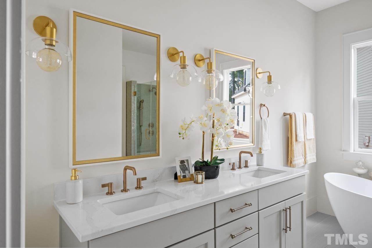 7204 Sing Along Court Raleigh, NC 27613 - Photo 46 of 46 a bathroom with a sink and a mirror