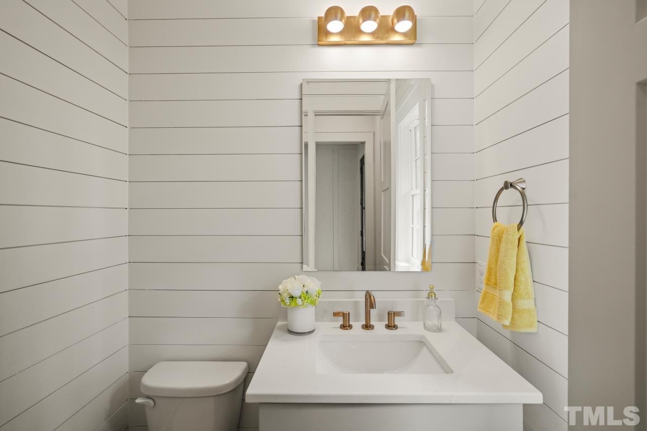 7204 Sing Along Court Raleigh, NC 27613 - Photo 7 of 46 a bathroom with a sink a toilet and mirror