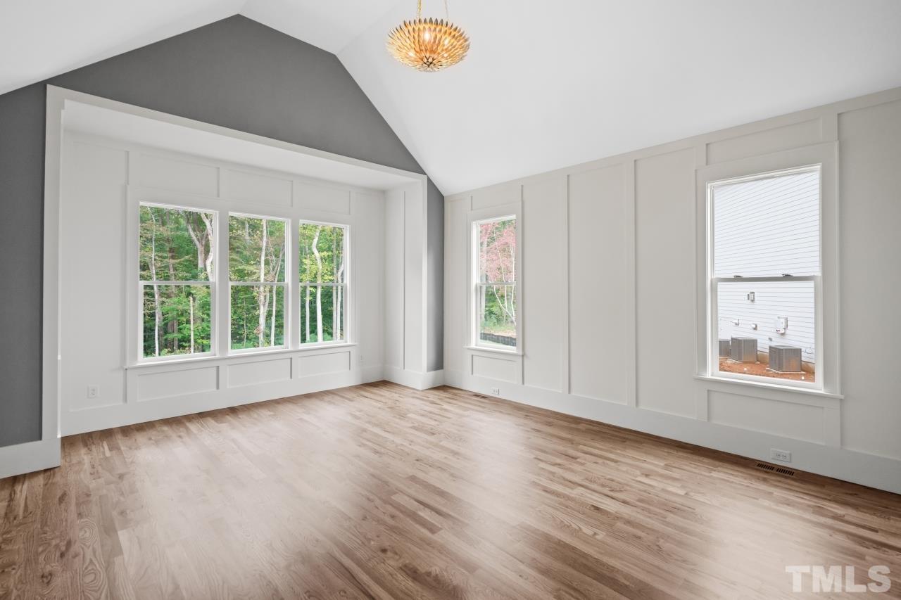 7204 Sing Along Court Raleigh, NC 27613 - Photo 10 of 46 a view of an empty room with window and wooden floor