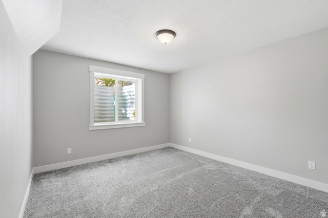 338 Windy Rdg Drive Smithfield, UT 84335 - Photo 44 of 63 Bedroom featuring light gray walls, plush gray carpeting, a single window with white trim, and a ceiling-mounted light fixture