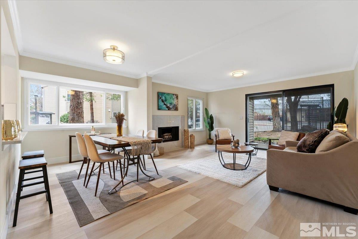 a living room with fireplace furniture and a large window