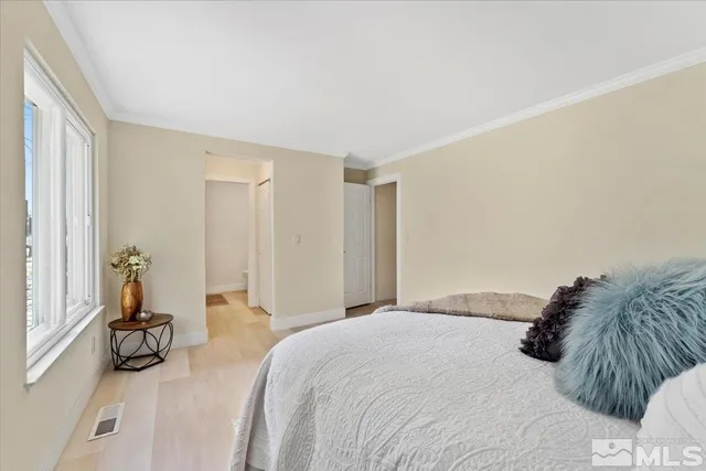 a bedroom with a bed and a view of bathroom