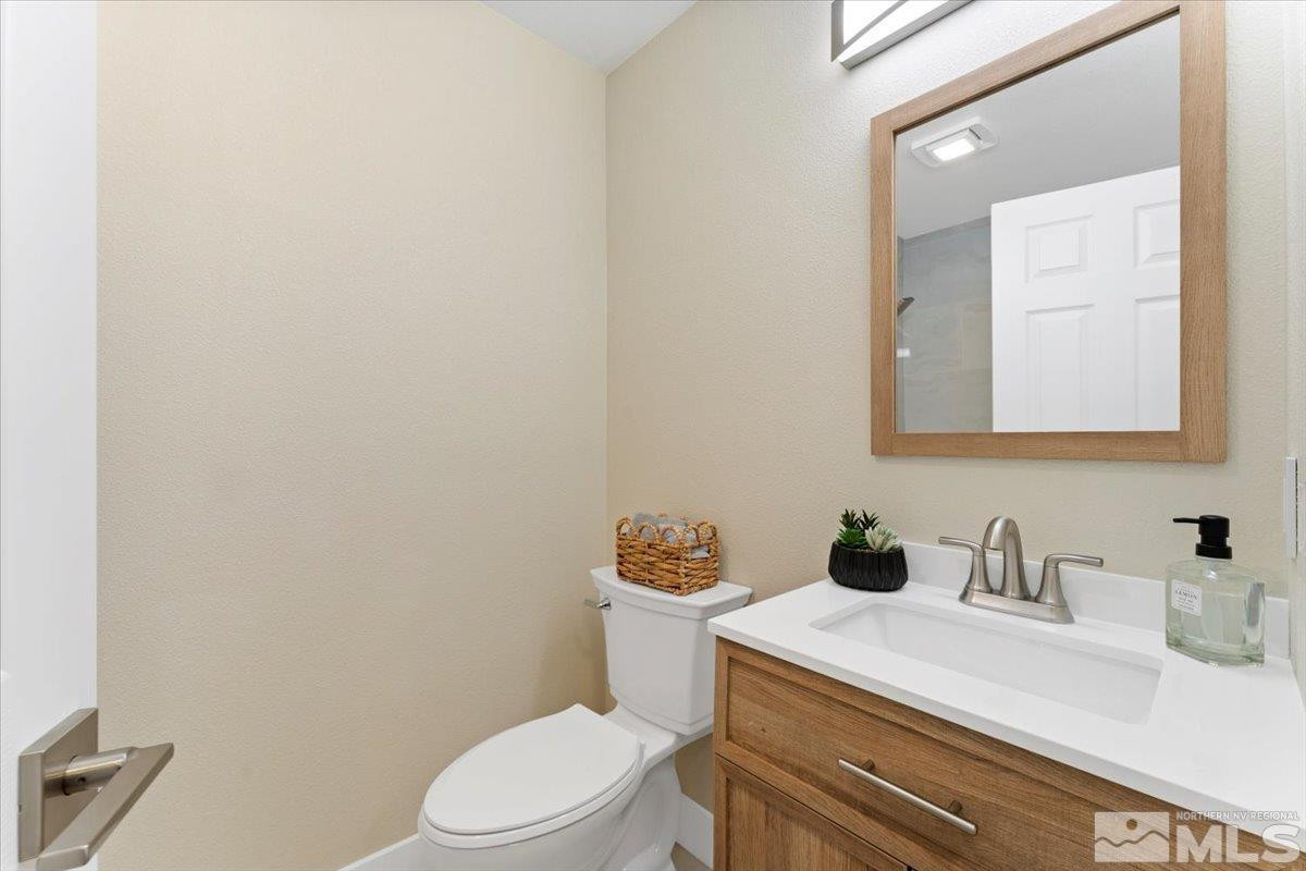2380 Roundhouse Road Sparks, NV 89431 - Photo 17 of 22 a bathroom with a toilet sink vanity and mirror