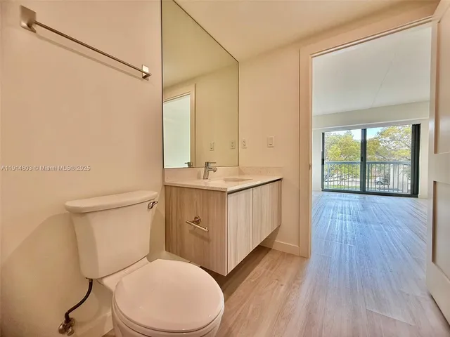 a bathroom with a toilet a sink and a mirror
