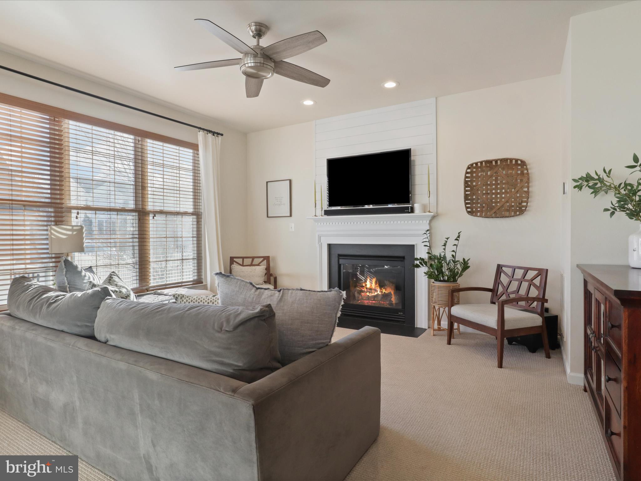 43081 Edgewater Street Chantilly, VA 20152 - Photo 11 of 50 a living room with furniture a fireplace and a flat screen tv
