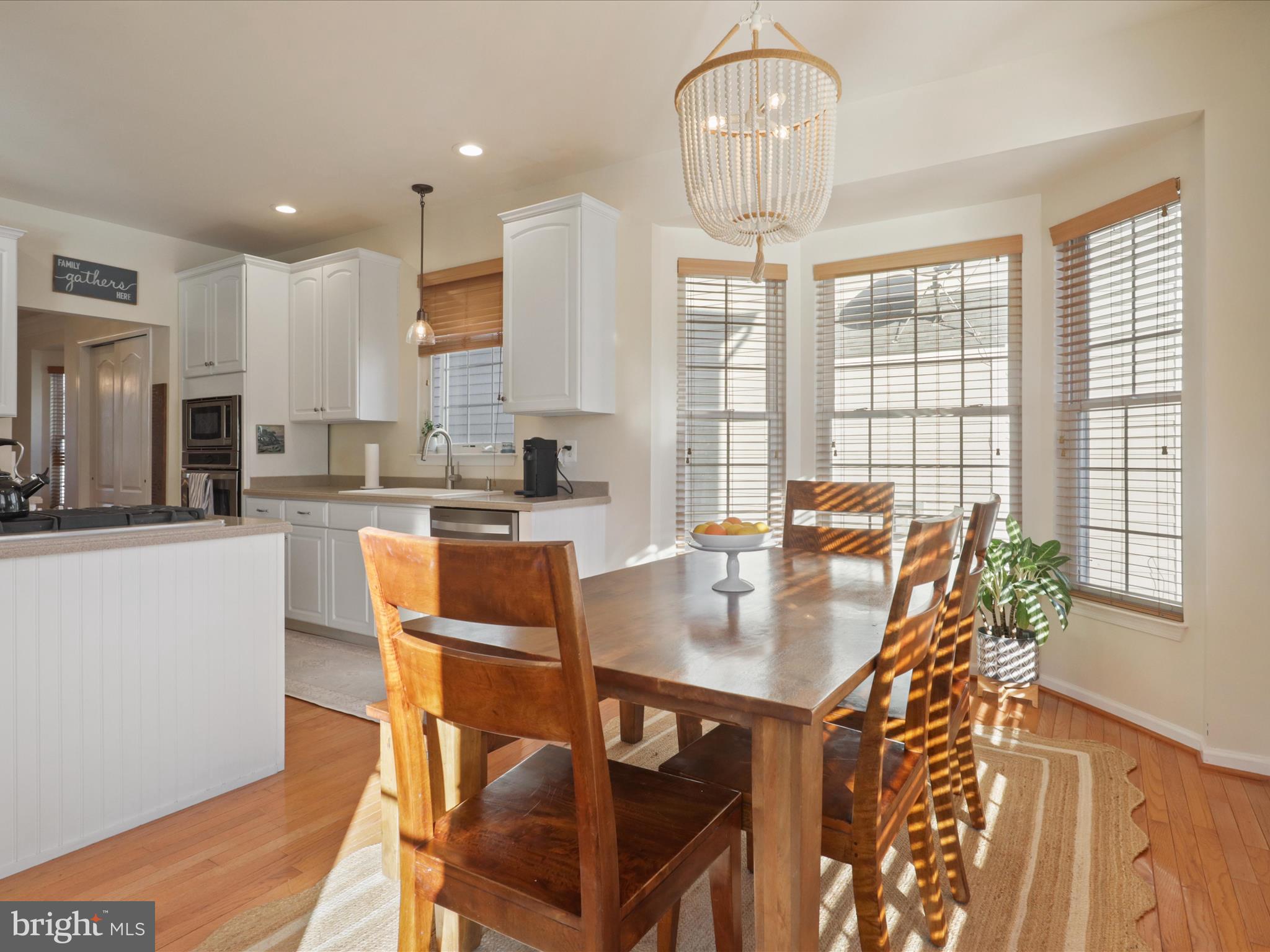 43081 Edgewater Street Chantilly, VA 20152 - Photo 14 of 50 a view of a dining room with furniture and a chandelier