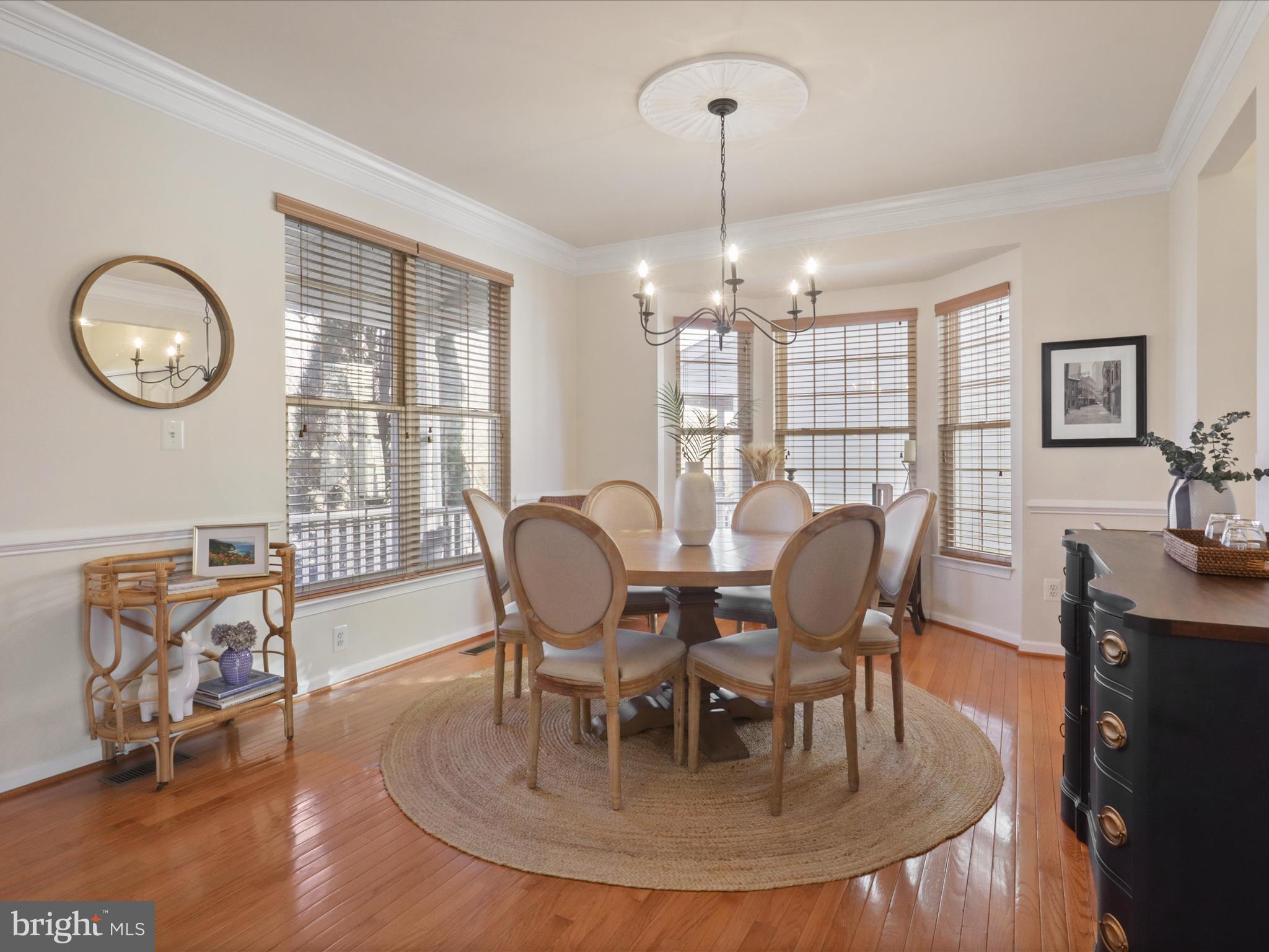 43081 Edgewater Street Chantilly, VA 20152 - Photo 6 of 50 a view of a dining room with furniture a chandelier and wooden floor