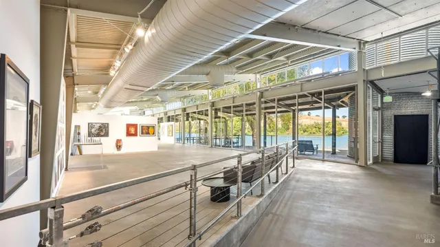 a porch with a table and chairs next to a yard