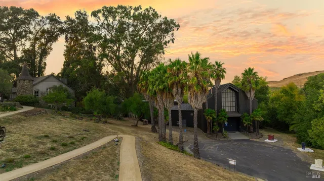 a view of a house with trees in the background