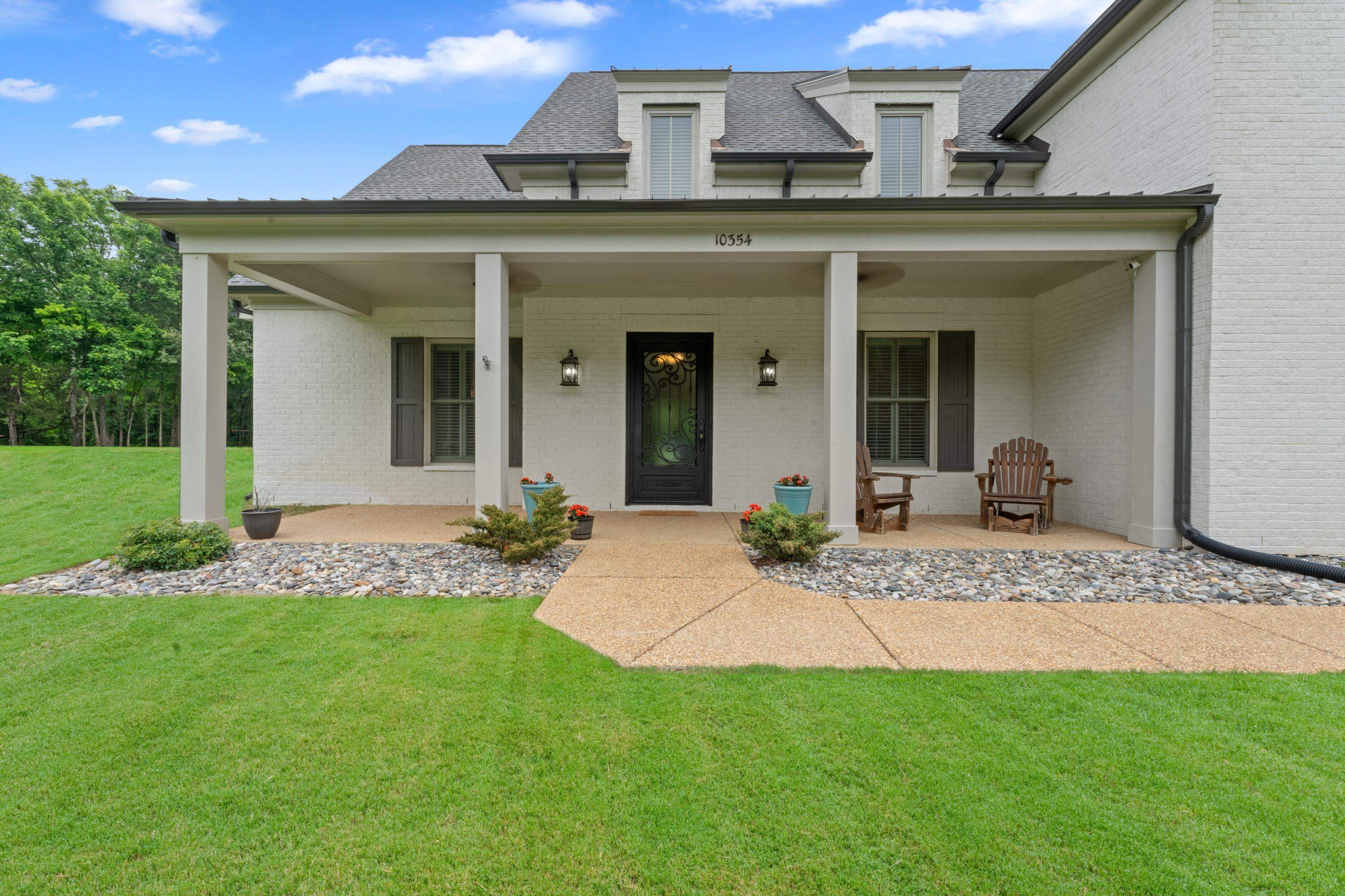 10354 Pleasant Ridge Road Arlington, TN 38002 - Photo 3 of 40 Charming covered front porch with elegant front door, classic brick exterior, and inviting seating areas that create warm curb appeal from the moment you arrive.
