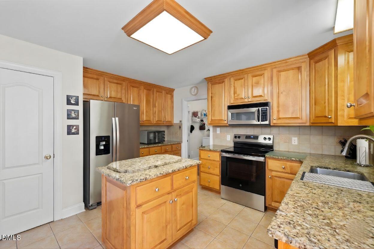 226 Marshview Circle Angier, NC 27501 - Photo 3 of 20 a kitchen with stainless steel appliances granite countertop a refrigerator stove microwave and sink