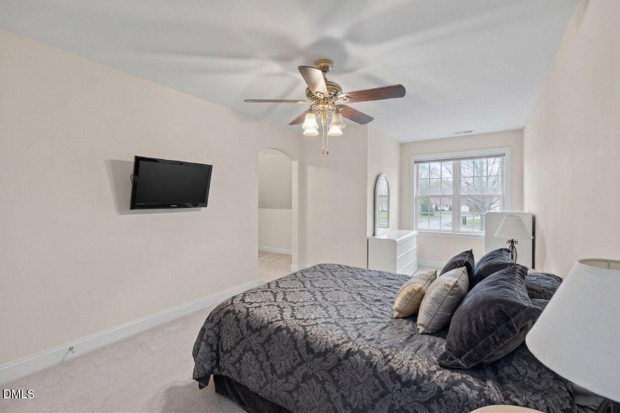 226 Marshview Circle Angier, NC 27501 - Photo 5 of 20 a bedroom with a bed window and a flat screen tv
