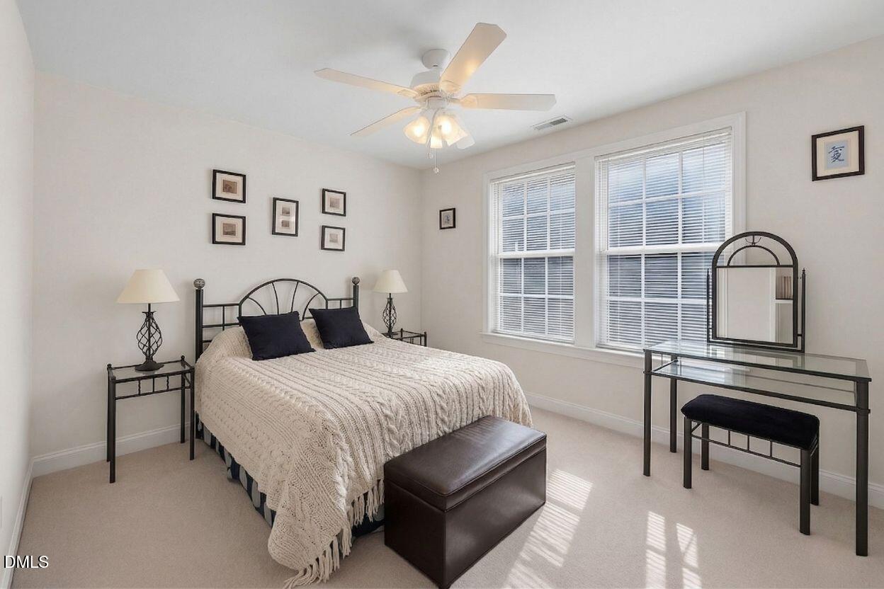 226 Marshview Circle Angier, NC 27501 - Photo 6 of 20 a bedroom with a bed next to a large window with a chandelier