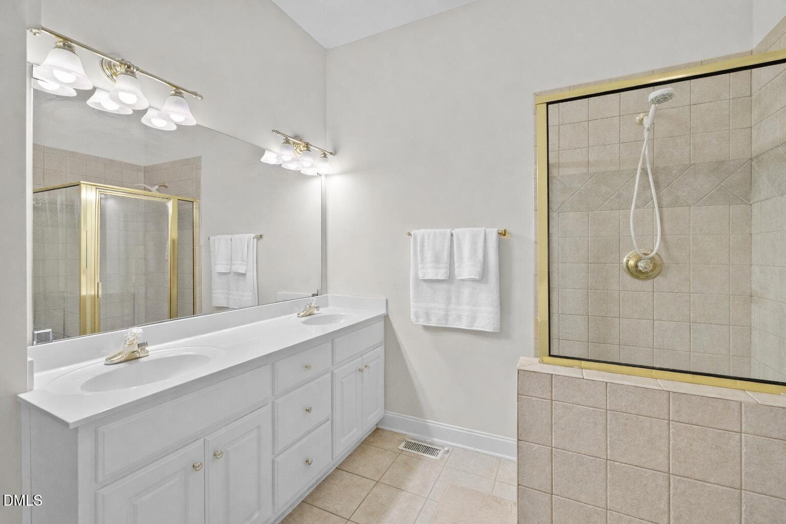 226 Marshview Circle Angier, NC 27501 - Photo 8 of 20 a bathroom with a double vanity sink mirror and shower
