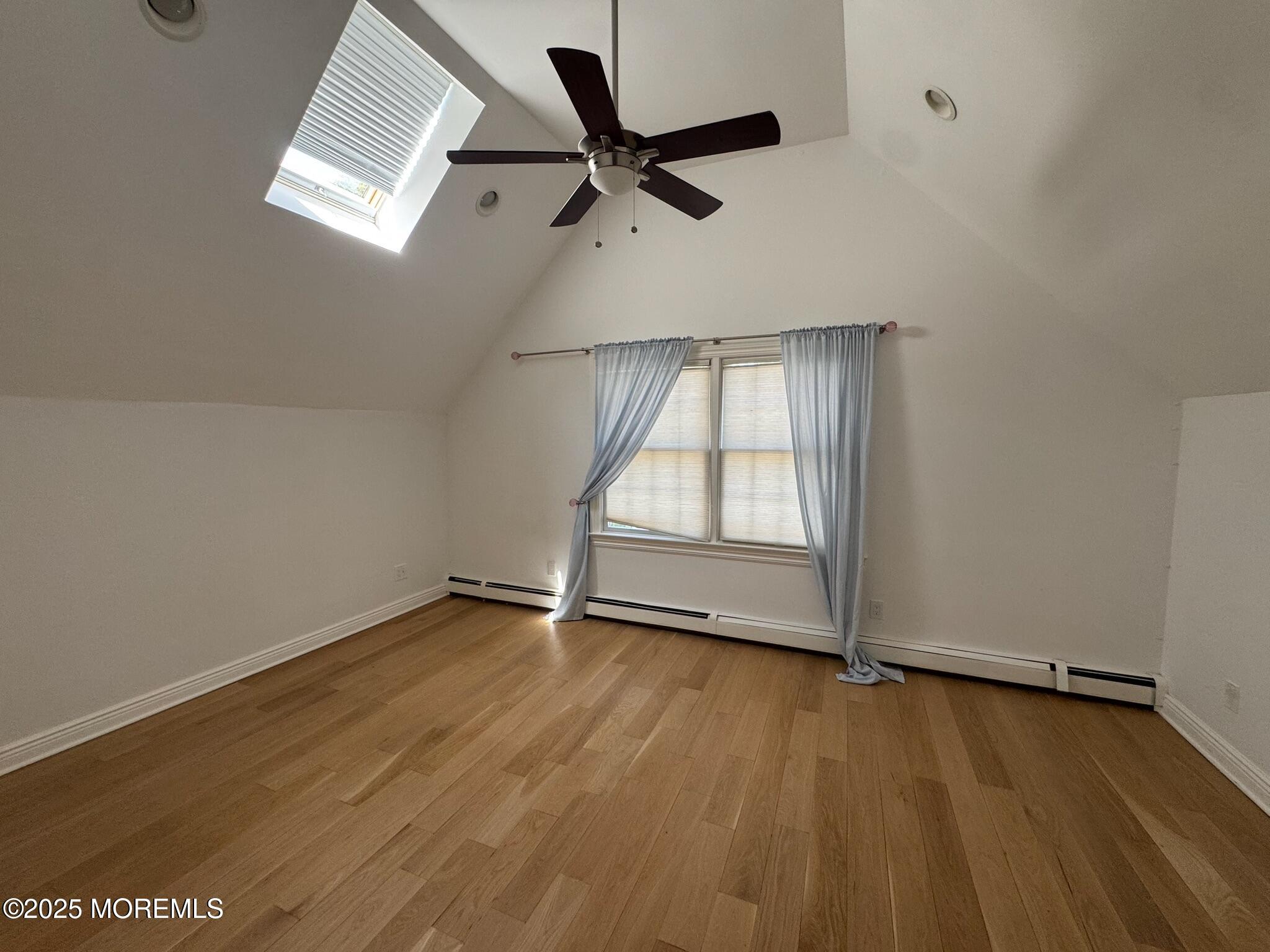 244 Van Kirk Avenue Atlantic Highlands, NJ 07716 - Photo 15 of 22 an empty room with wooden floor fan and windows