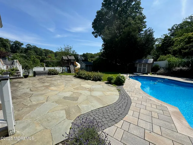 a view of a swimming pool with a patio