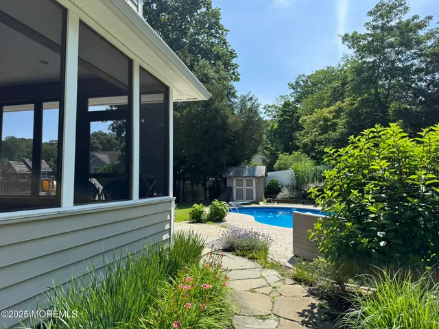 a view of a house with porch and garden