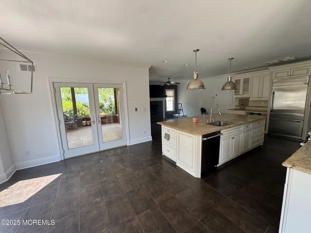 a large white kitchen with a large window