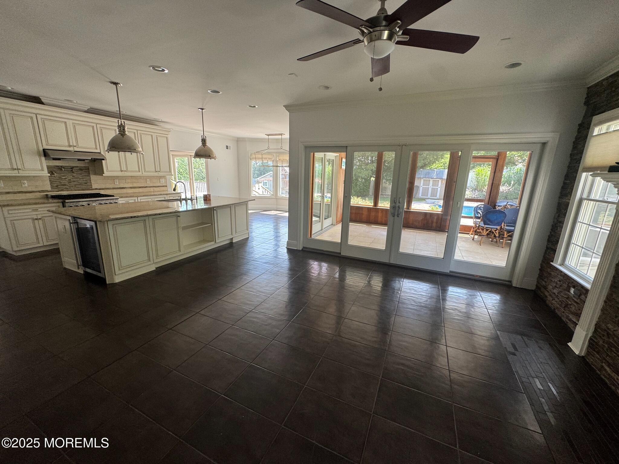244 Van Kirk Avenue Atlantic Highlands, NJ 07716 - Photo 5 of 22 a kitchen with stainless steel appliances a large window a oven a sink with a dining table and chairs