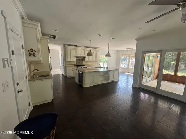 a view of a kitchen with refrigerator and wooden floor
