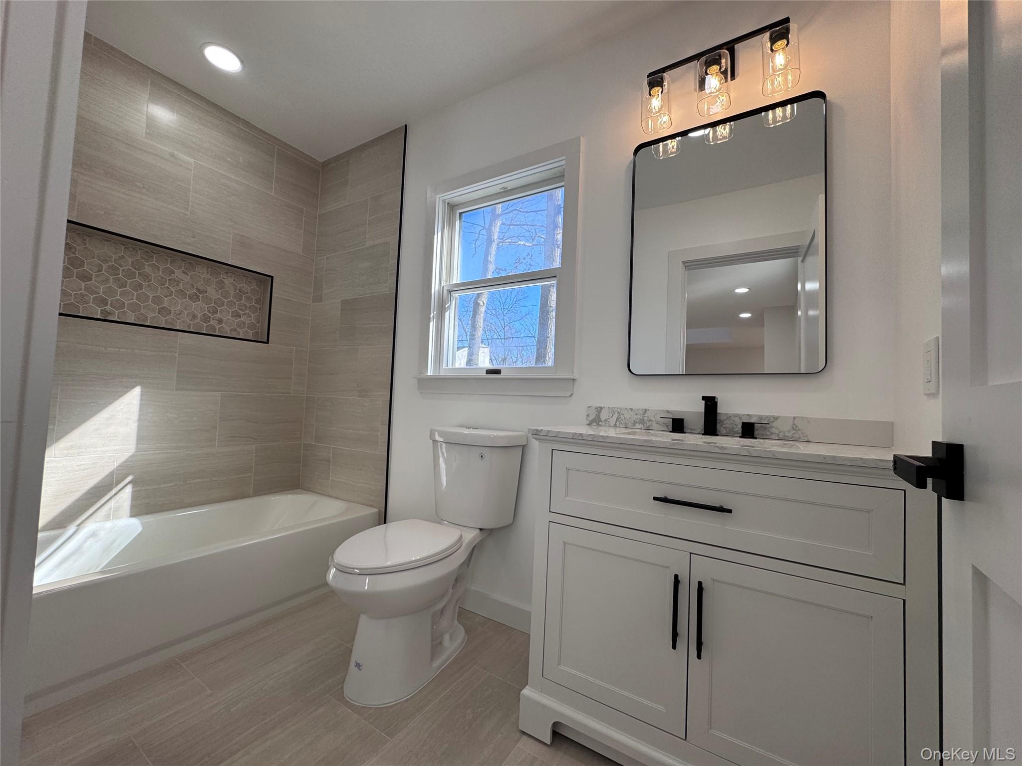 277 Prince Road Rocky Point, NY 11778 - Photo 12 of 13 New Full Bath with new tiled shower/tub, flooring and ew quartz top vanity