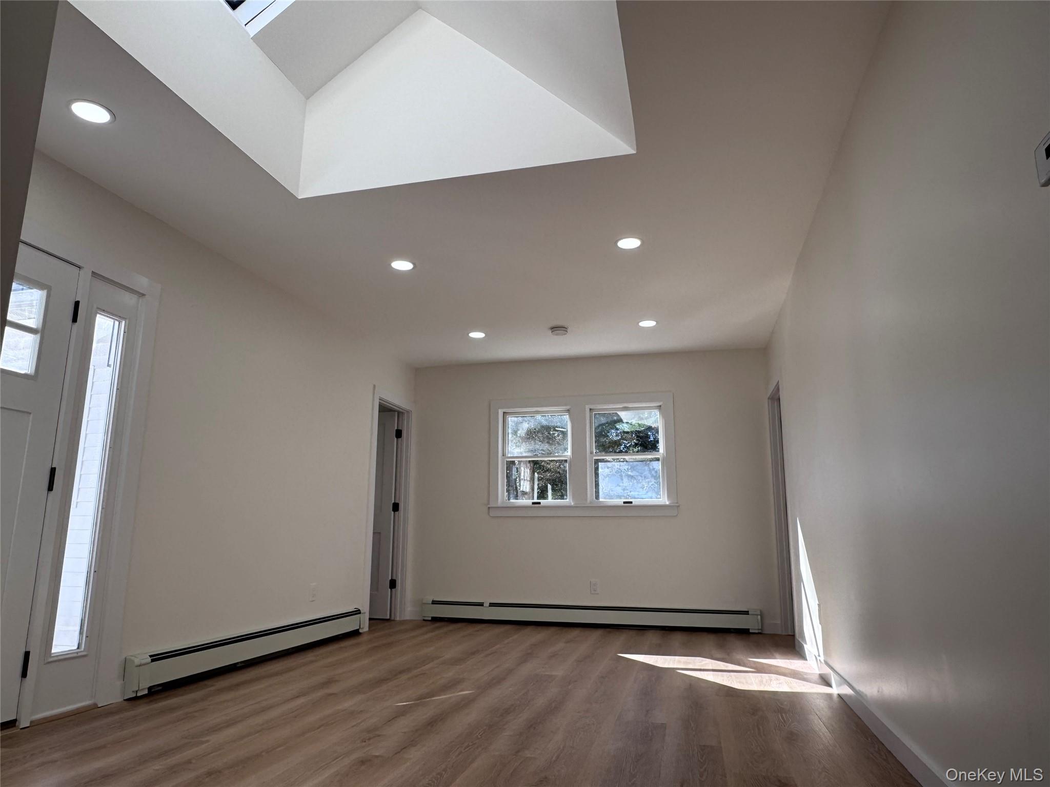 277 Prince Road Rocky Point, NY 11778 - Photo 5 of 13 Living room with vaulted ceilings, recessed lighting and new flooring