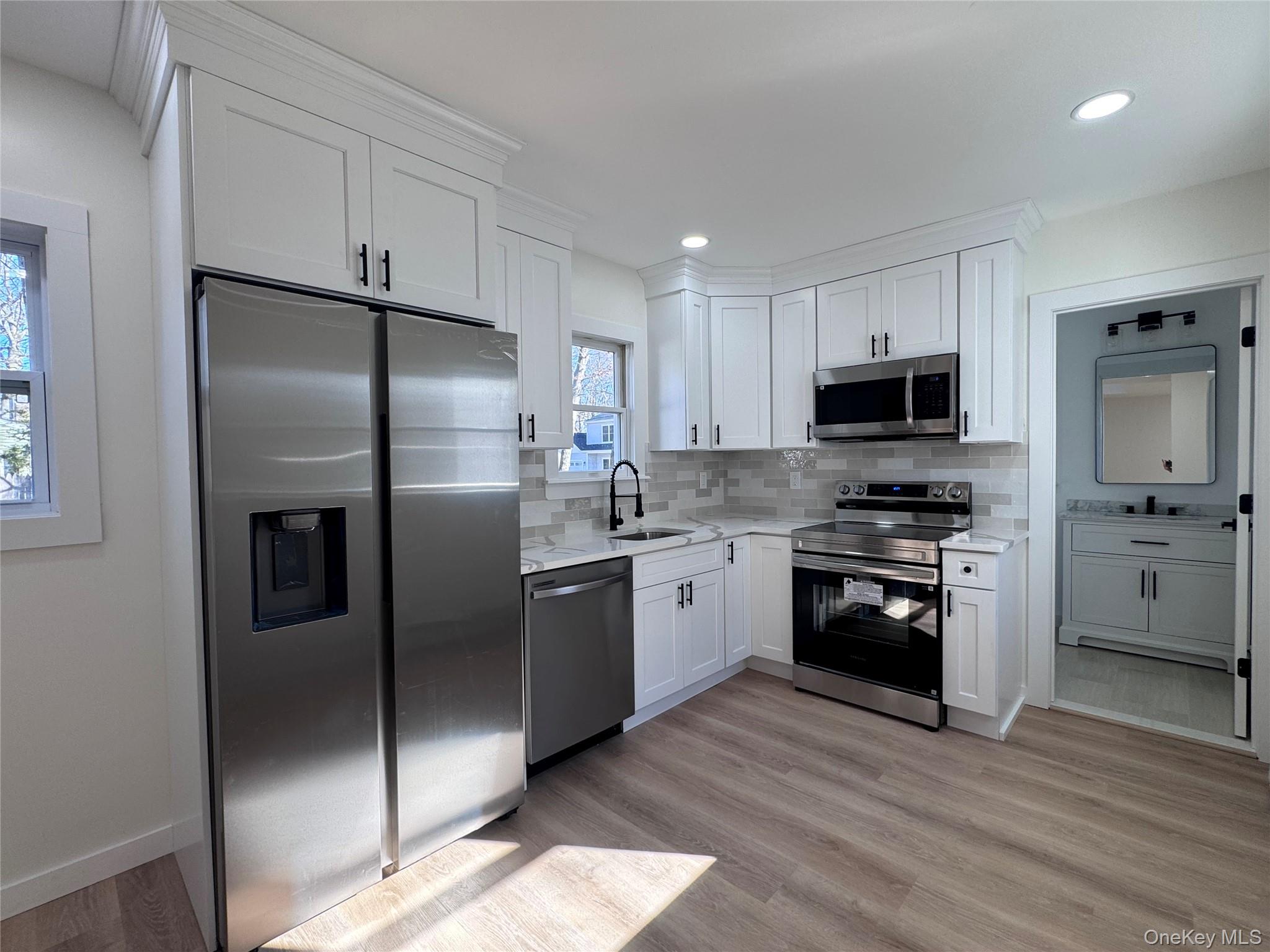 277 Prince Road Rocky Point, NY 11778 - Photo 8 of 13 New Kitchen with quartz countertops, soft close cabinetry, and new ss appliances