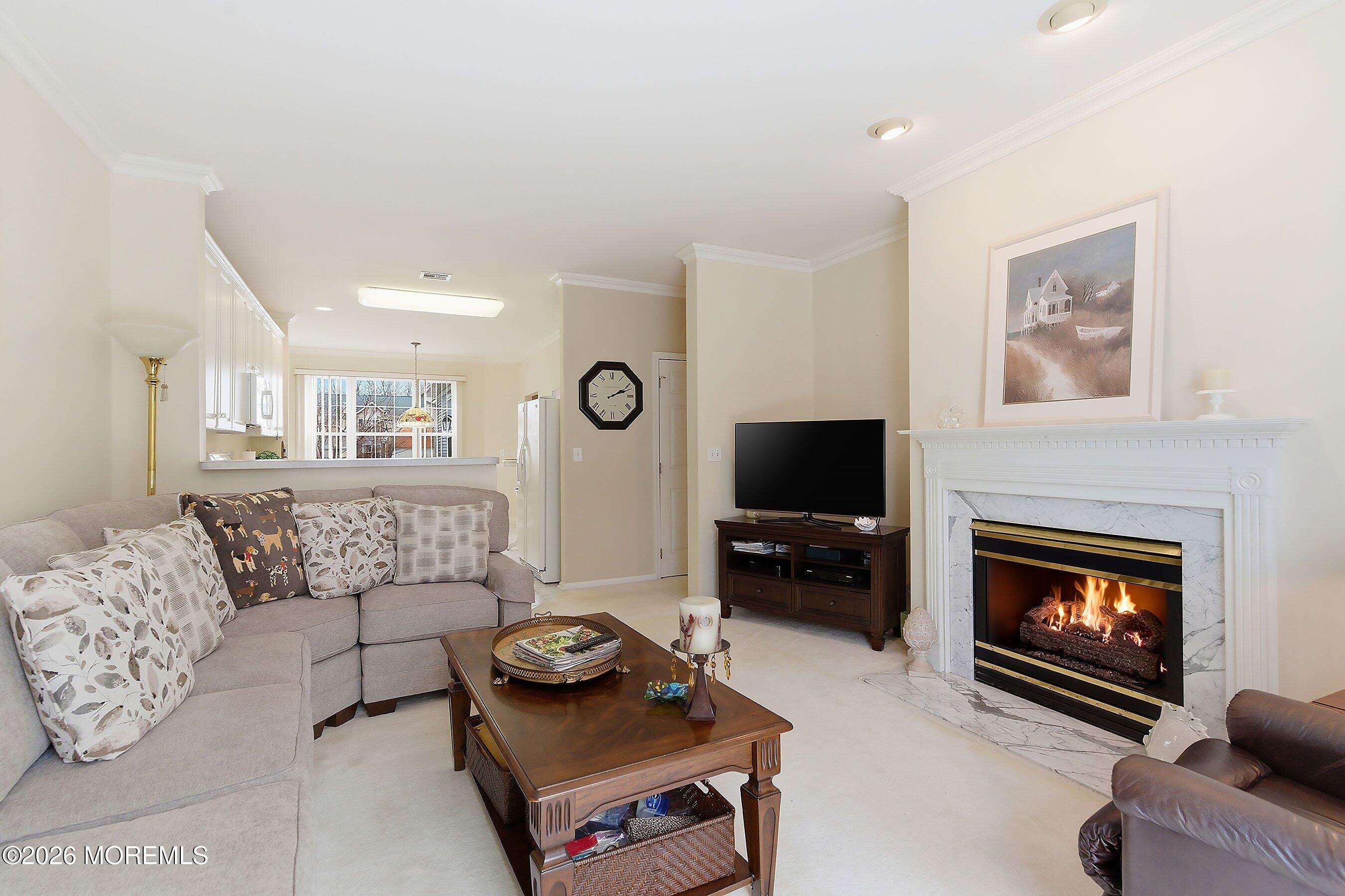 2409 Robin Way Manasquan, NJ 08736 - Photo 12 of 40 a living room with furniture and a fireplace