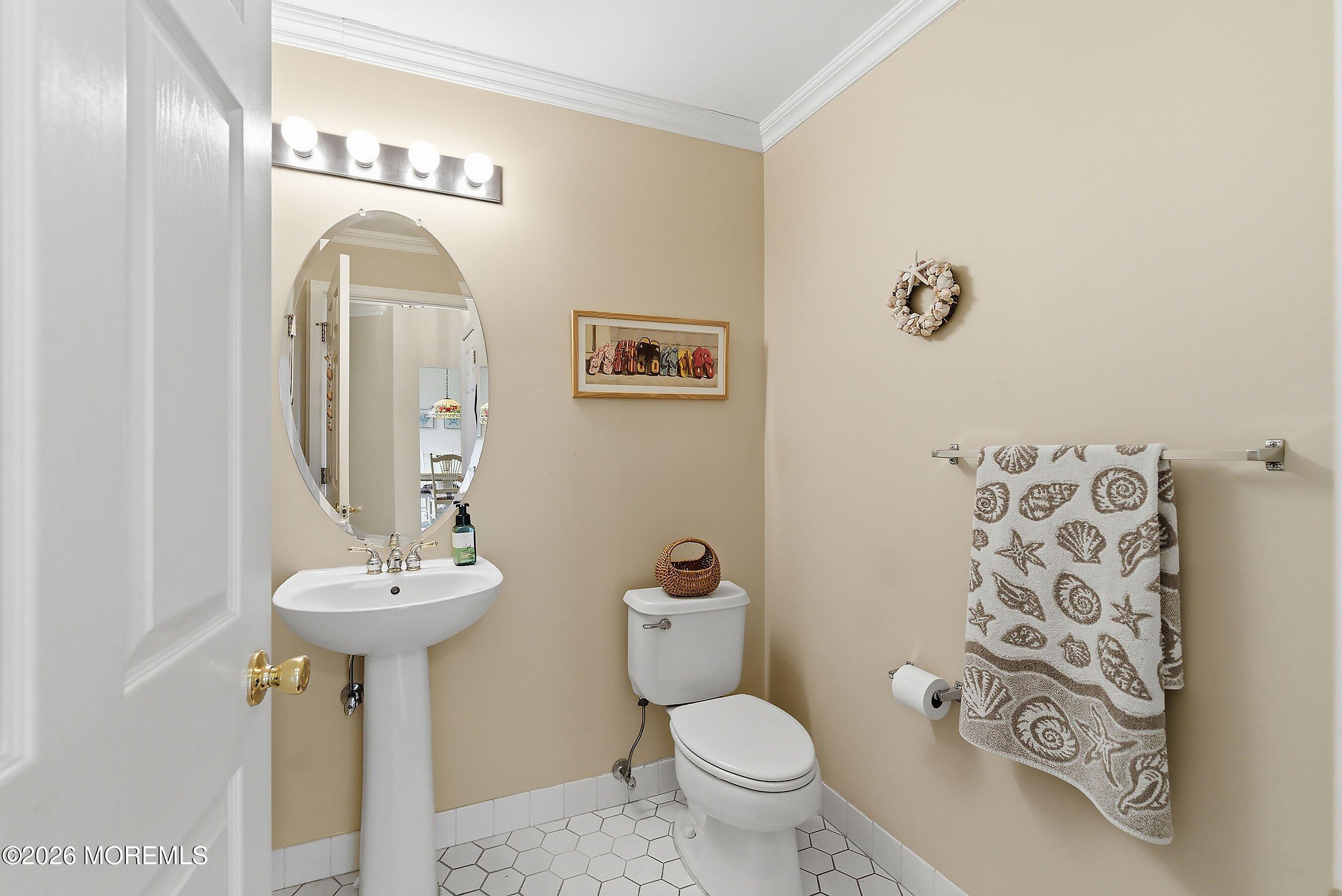 2409 Robin Way Manasquan, NJ 08736 - Photo 14 of 40 a bathroom with a toilet sink and mirror