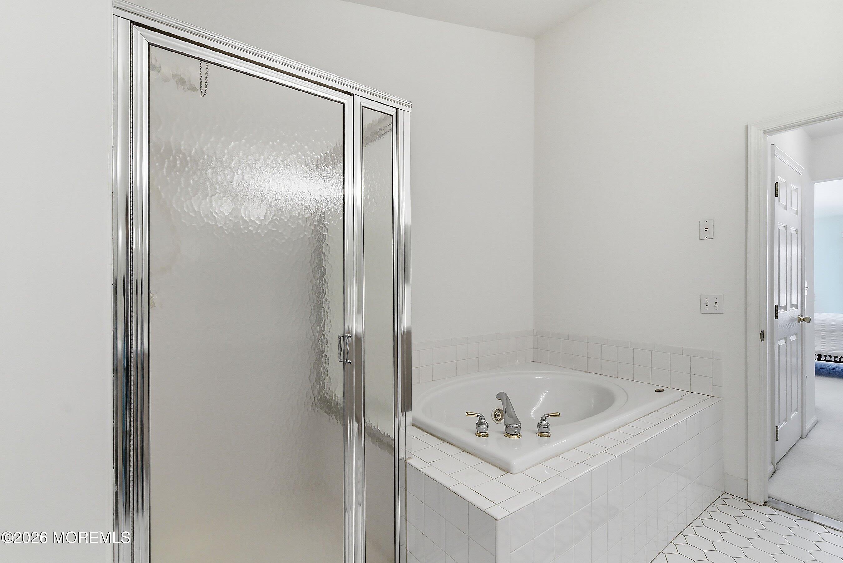 2409 Robin Way Manasquan, NJ 08736 - Photo 16 of 40 a bathroom with a bathtub and a shower