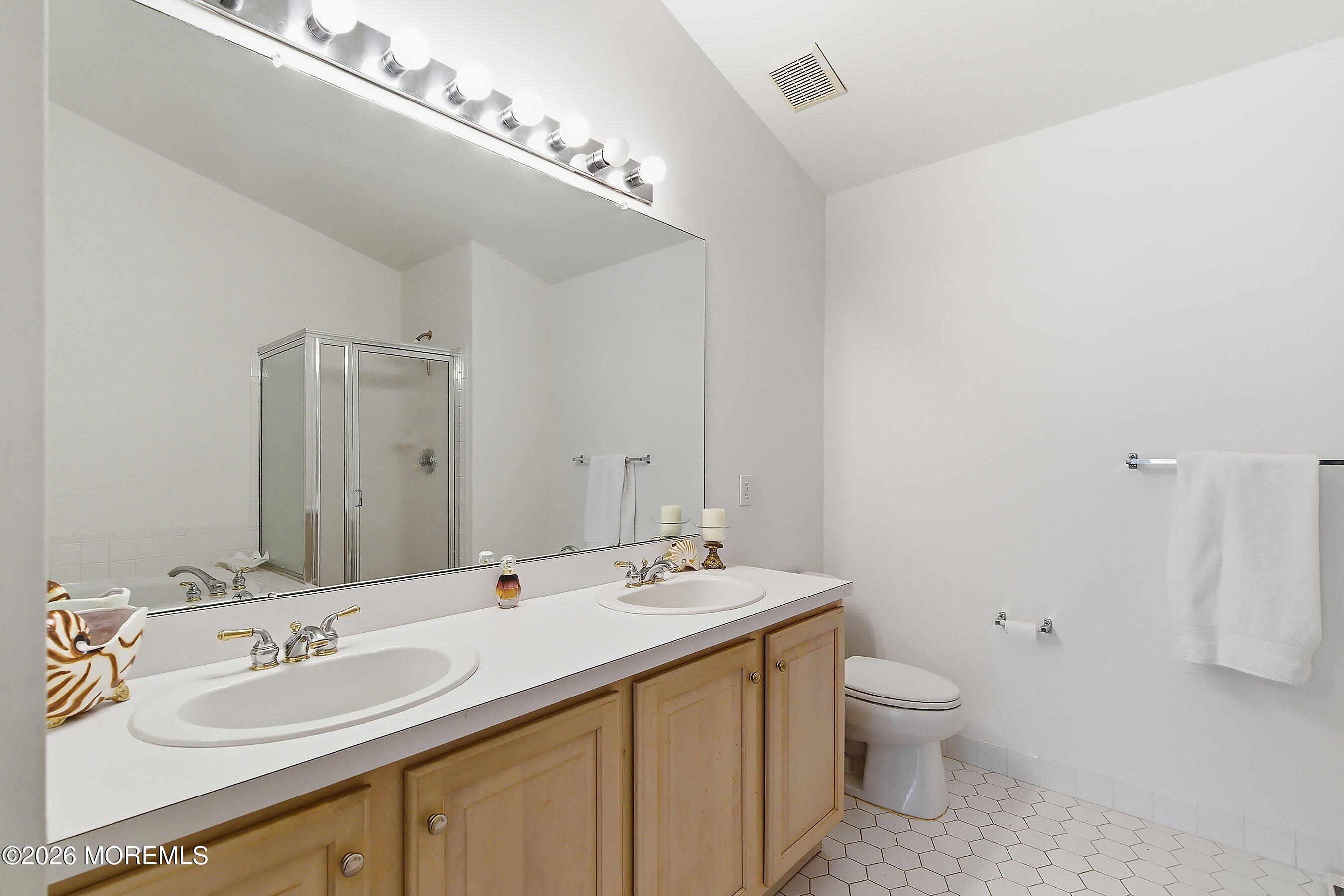 2409 Robin Way Manasquan, NJ 08736 - Photo 17 of 40 a bathroom with a double vanity sink and a mirror