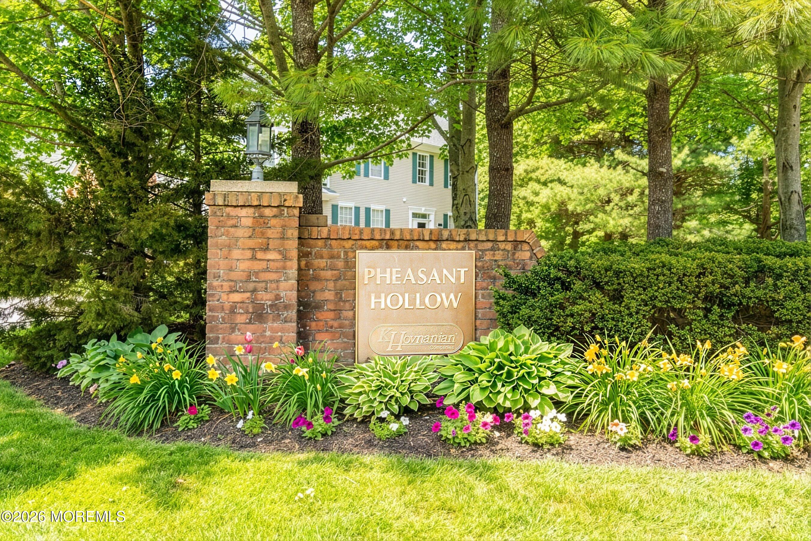 2409 Robin Way Manasquan, NJ 08736 - Photo 2 of 40 a sign that is sitting in the garden