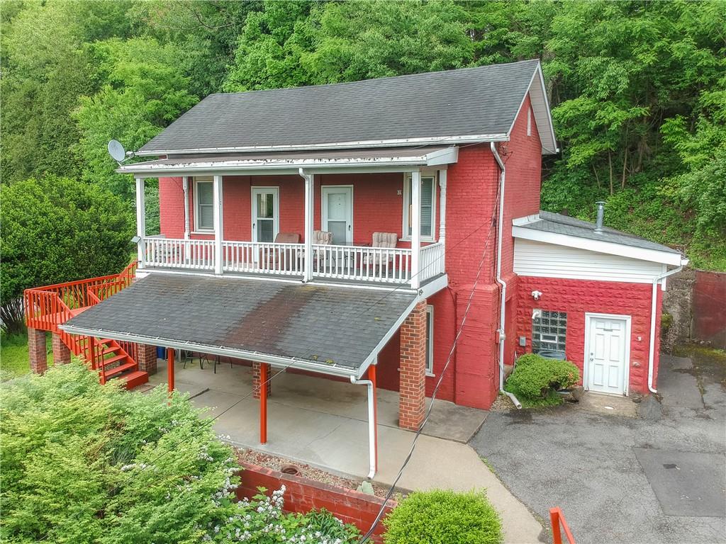 Front 3/4 - covered porch and patio.