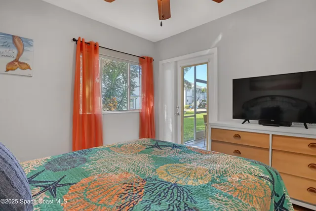 a bedroom with a bed and a painting on the wall